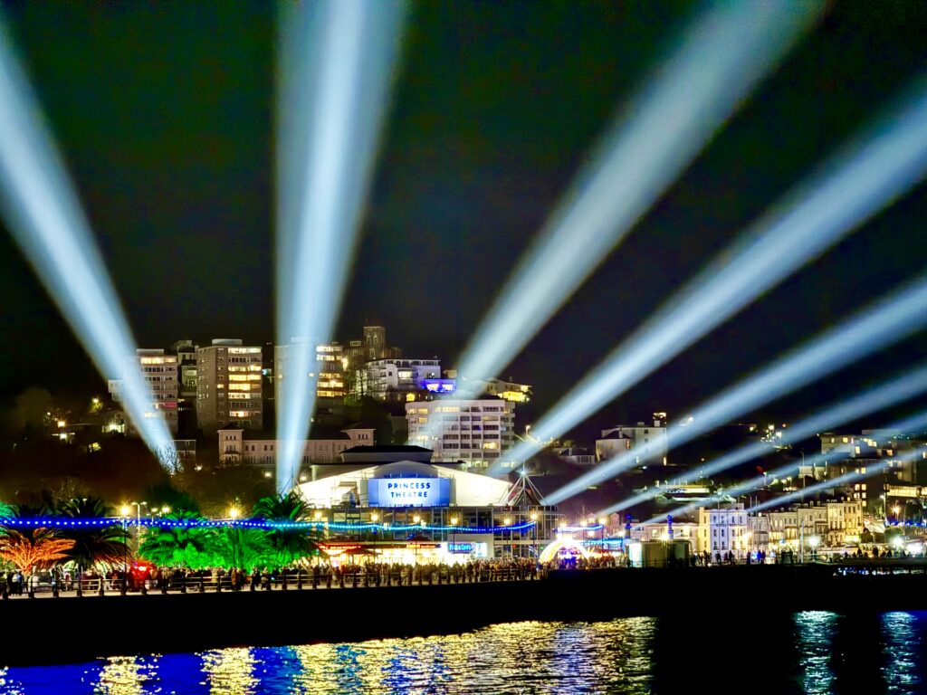 Bay of Lights illuminations shining across Torquay seafront and harbour at night