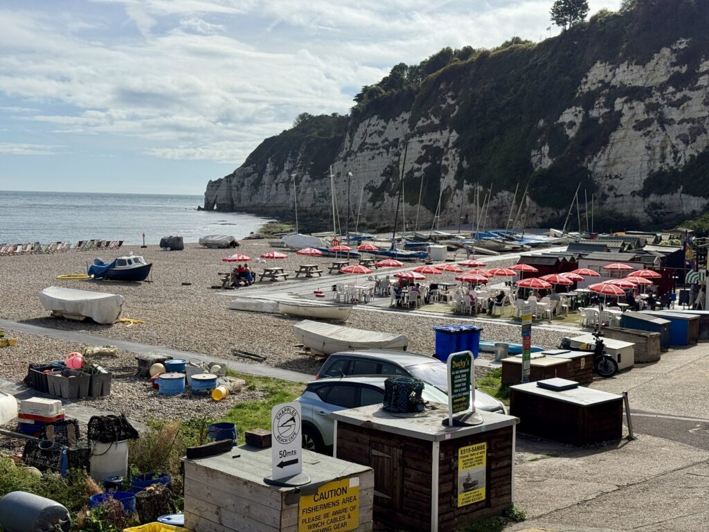 Beer Beach cafés, fishing boats and chalk cliffs below Beer Head in East Devon