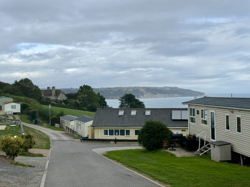 Sea view from Beer Head Bistro across Beer Head Holiday Park towards the cliffs and coastline of Lyme Bay.
