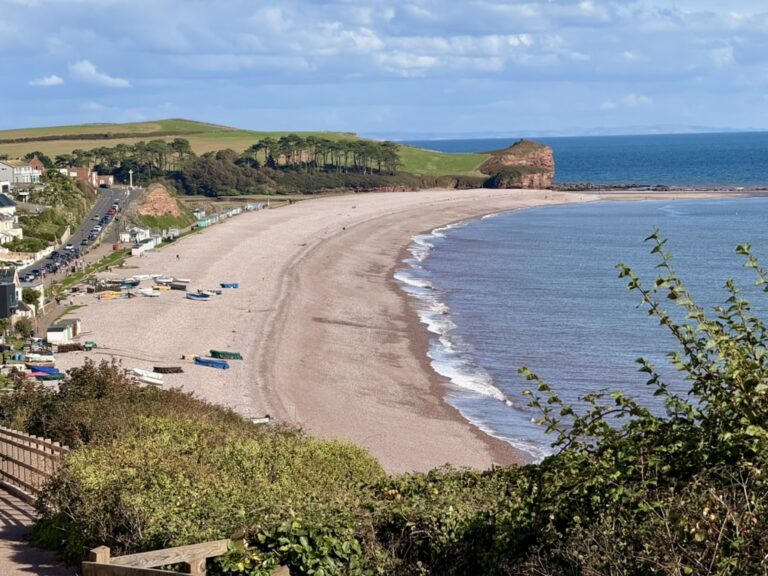 Budleigh Salterton beach, showing the pebble beach, the sea, the Otter Estuary and the red cliffs