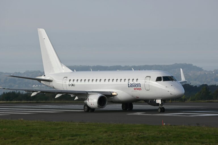 Eastern Airways Embraer 170 regional jet taxiing on the runway at a UK airport, photographed by Wayne Jackson.