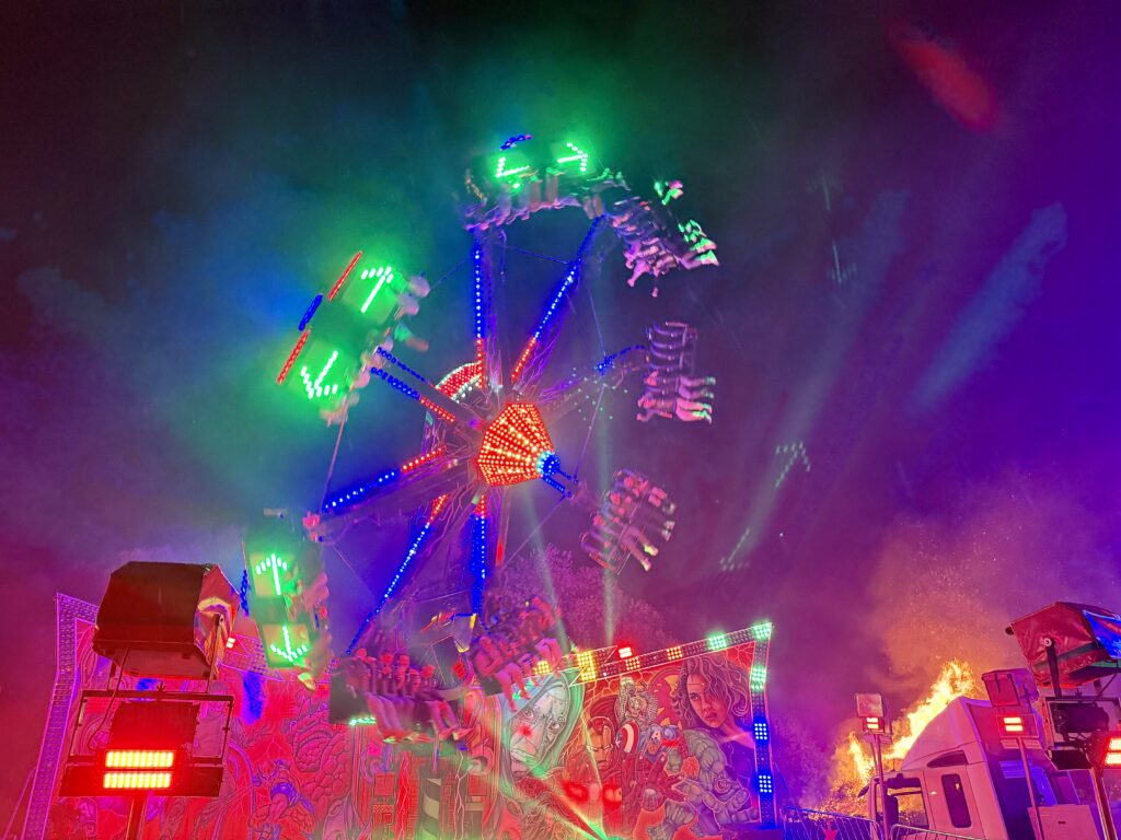 Illuminated fairground ride at the Ottery St Mary Tar Barrels.
