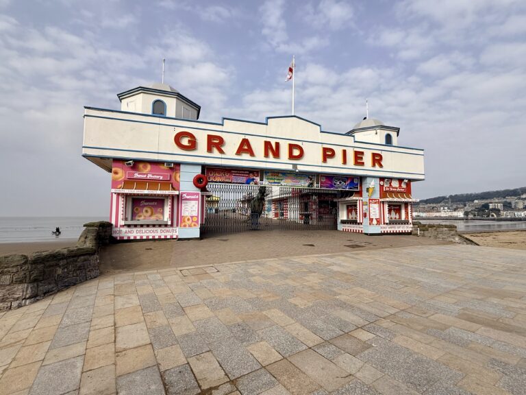Entrance to the Grand Pier in Weston-super-Mare on the Somerset coast, a popular seaside attraction visited by tourists and day visitors to Weston Bay.