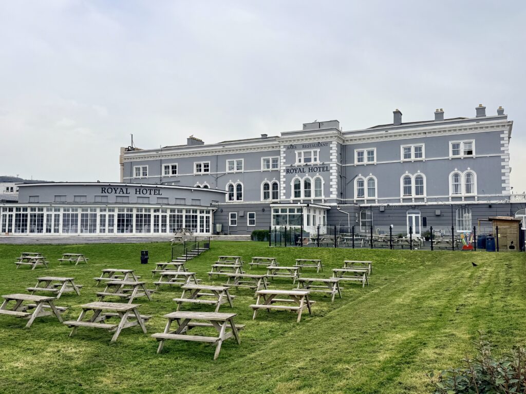 The Royal Hotel on the seafront in Weston-super-Mare with outdoor seating and lawn area overlooking Weston Bay on the Somerset coast.
