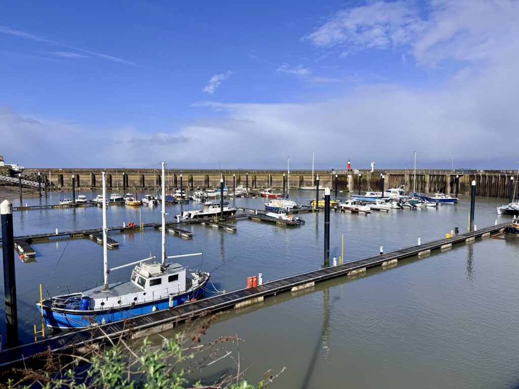 Watchet harbour and marina in Somerset with moored boats, calm water and views across Bridgwater Bay on a clear day