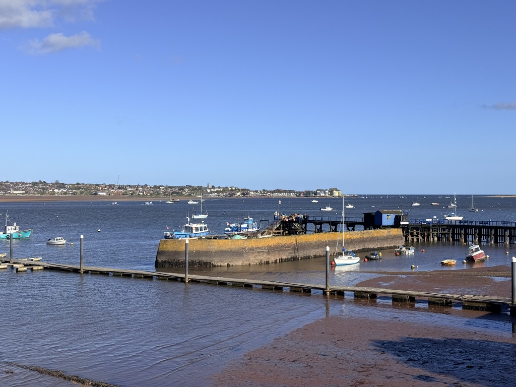 Starcross Ferry pier on the Exe Estuary, Devon with boats at low tide and views across the water towards Exmouth.