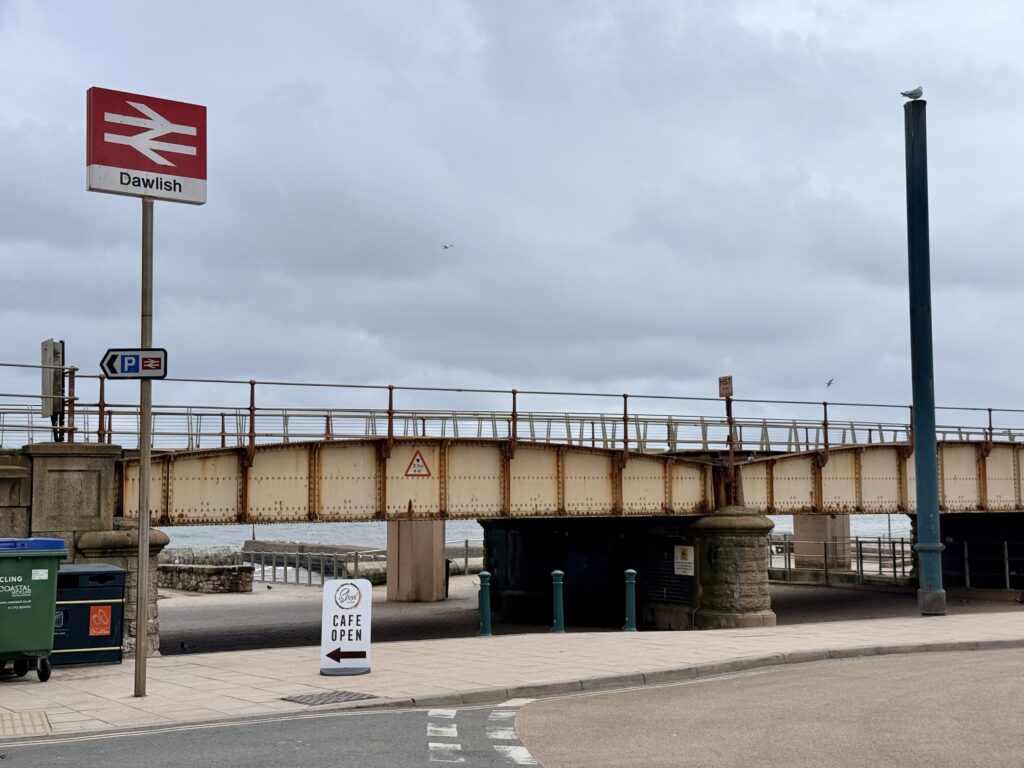 Dawlish railway station bridge and sea wall, Devon with coastal path and access beneath the railway line.