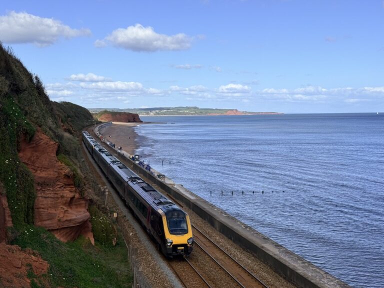 Great Western Railway train passing Dawlish sea wall on the South Devon coast. A popular way to get to the Torbay Airshow.