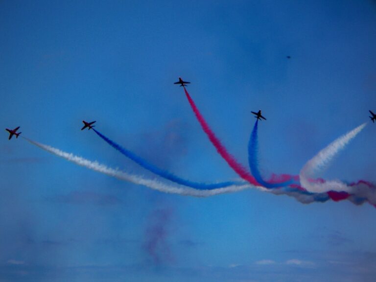 RAF Red Arrows display at the English Riviera Airshow 2026 over Torbay with red, white and blue smoke trails.