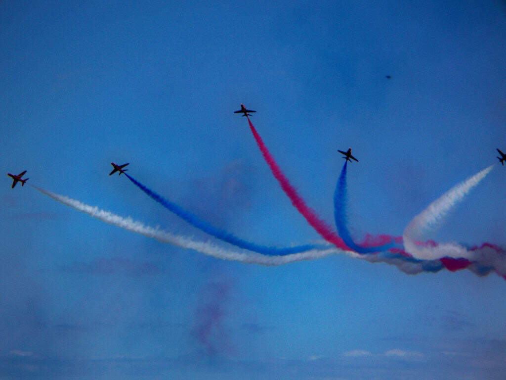 RAF Red Arrows display at the English Riviera Airshow 2026 over Torbay with red, white and blue smoke trails.