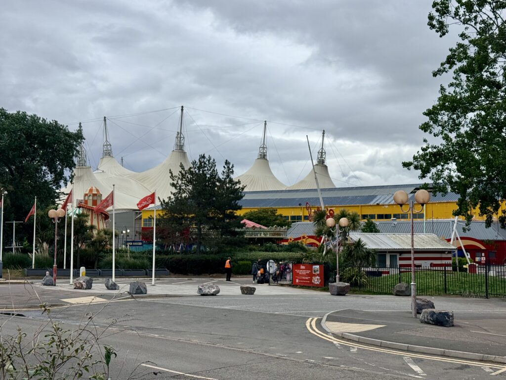 Butlin’s Minehead main entrance showing the large white tented skyline pavilion, colourful flags and the resort entrance on the Somerset seafront.