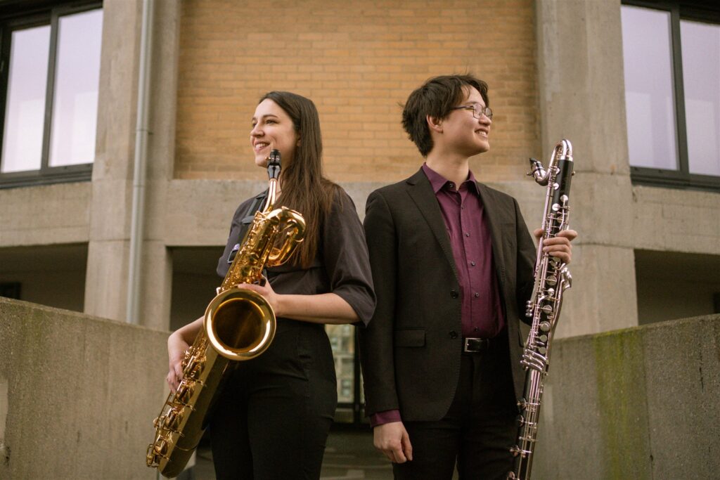 Kirsten Beveridge and Henry McNamara of DOOT holding a baritone saxophone and bass clarinet.