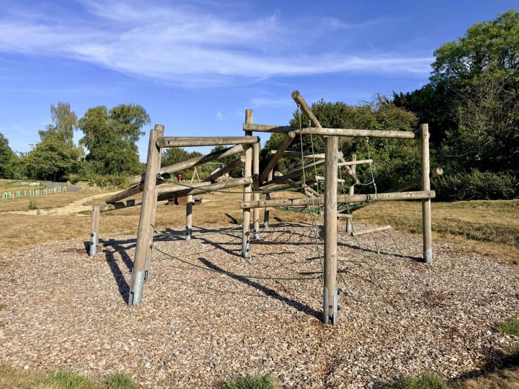 Wooden climbing frame with ropes and balancing beams in the play area at Sutton Bingham Reservoir.