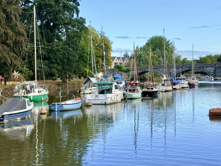 Boats moored on the River Dart at Totnes, close to the effective end of navigation near Totnes Bridge.