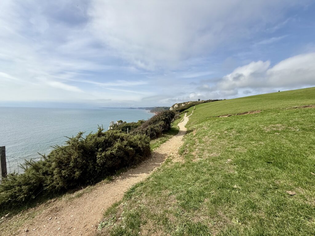 South West Coast Path following the grassy clifftop between Branscombe and Beer, with Lyme Bay stretching into the distance.