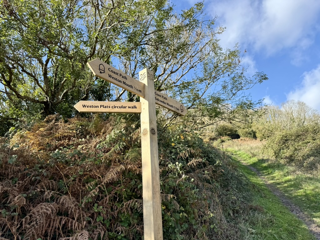 South West Coast Path signpost near Branscombe pointing towards Weston Mouth, Salcombe Mouth and the Weston Plats circular walk.