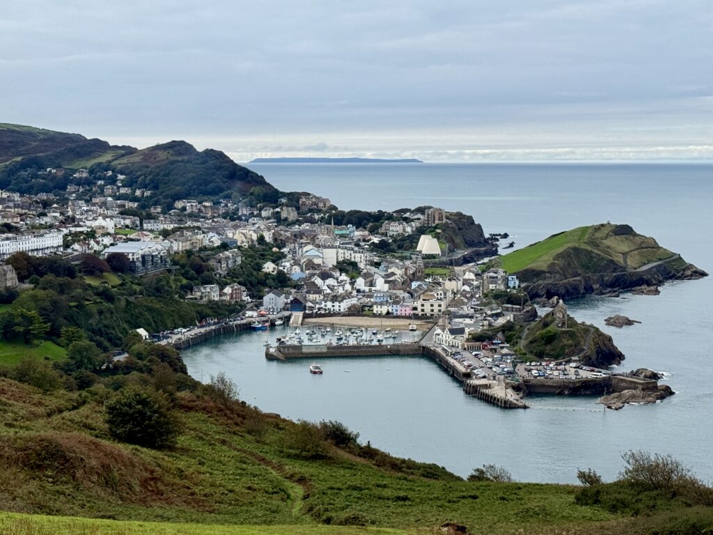 View across Ilfracombe harbour and town from Hillsborough, with the North Devon coast and Lundy visible in the distance.