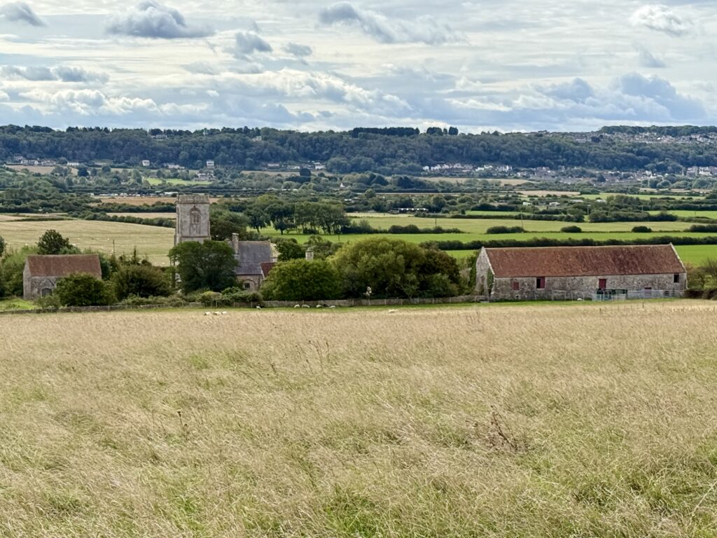 Woodspring Priory and medieval barn seen from Middle Hope near Sand Point